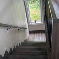 Finished dark wood staircase with matching railings