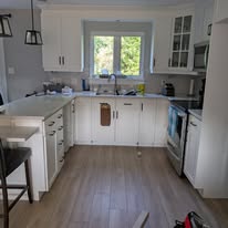 The kitchen with white cabinetry after the update