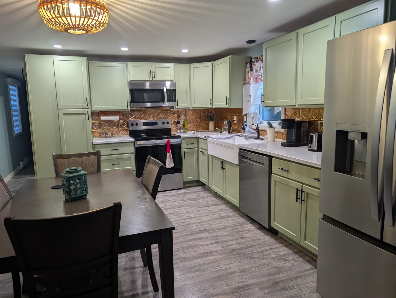 Completed kitchen with soft green cabinetry