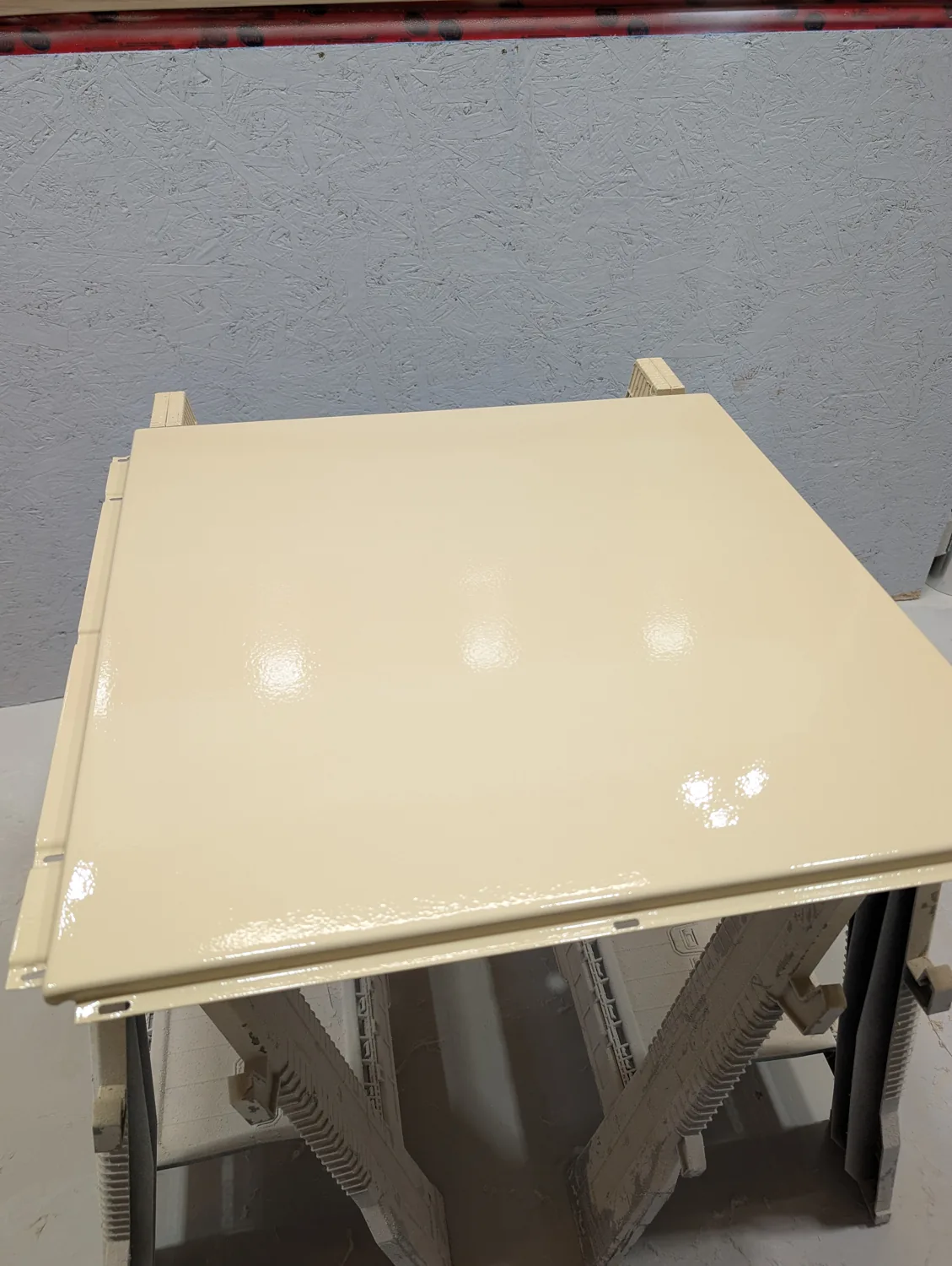 Glossy cabinet panel after spray finishing